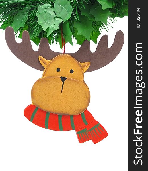 Wooden reindeer tree ornament hanging from a green garland