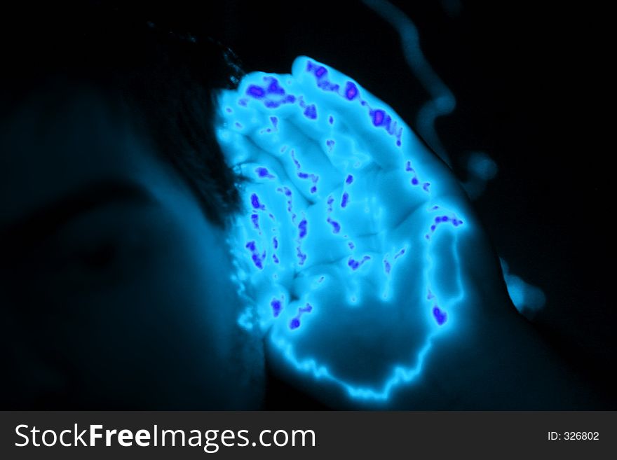 Man holding a glowing hand at his ear. Man holding a glowing hand at his ear