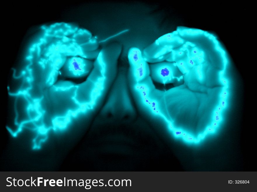 Man with glowing hands at his eyes. Man with glowing hands at his eyes