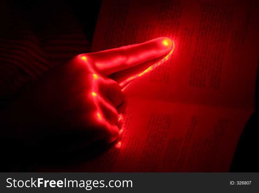 Glowing hand on a book