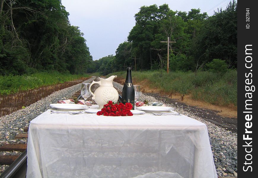 A full dinner set upon the railroad tracks. A full dinner set upon the railroad tracks.