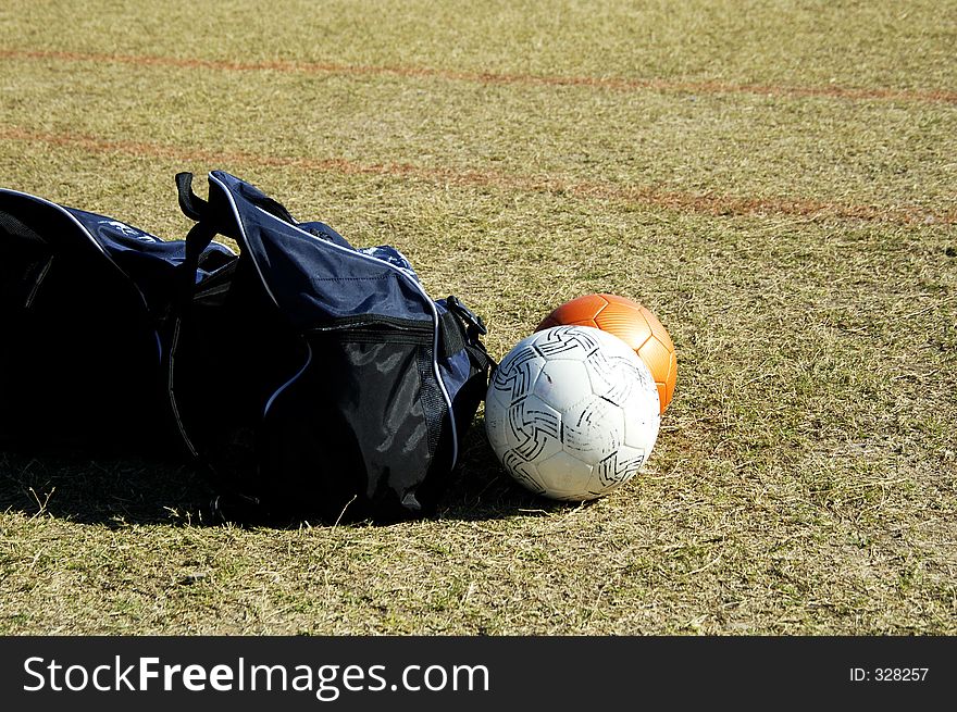 Bags and balls on the soccer field sidelines. Bags and balls on the soccer field sidelines.