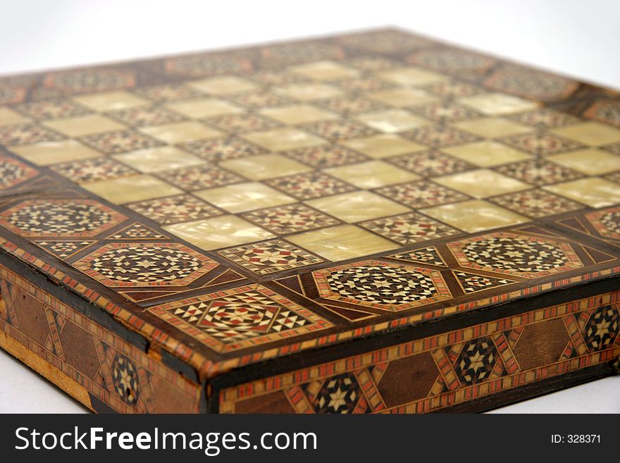 Antique foldable wooden chessboard with 'mother of pearl' squares set in. Antique foldable wooden chessboard with 'mother of pearl' squares set in.