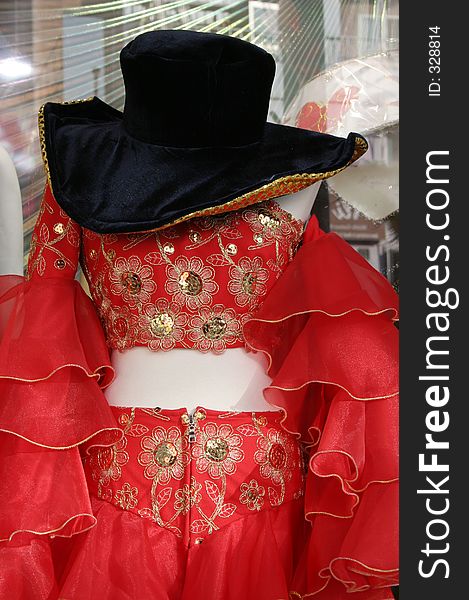 Red fancy dress costume with a black hat