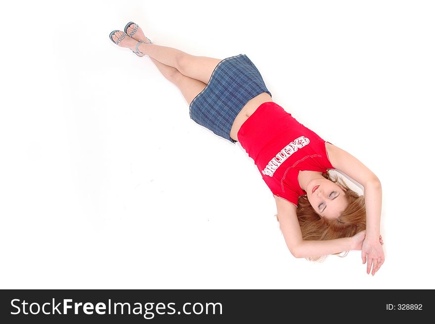 Sporty dressed girl rests laying on a white floor. Sporty dressed girl rests laying on a white floor