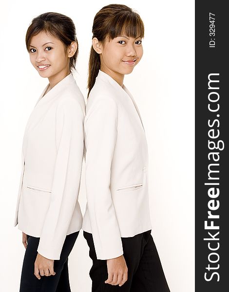 Two attractive young asian women in matching white jackets. Two attractive young asian women in matching white jackets