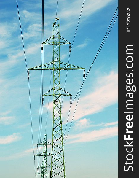 High voltage tower over cloudy blue sky. High voltage tower over cloudy blue sky