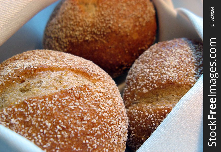 Three warm bread rolls in a basket