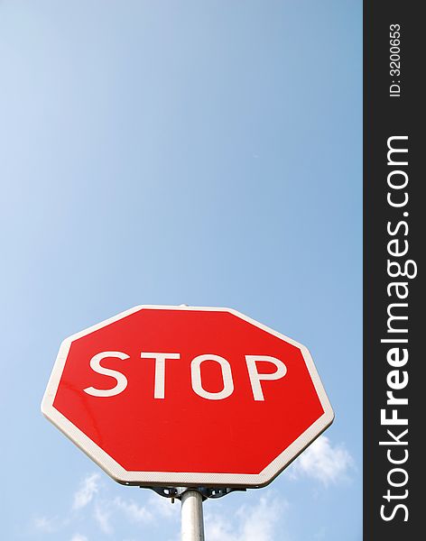 Stop sign on the blue sky