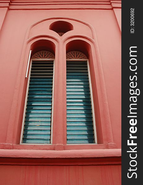 A window of an old colorful building. A window of an old colorful building