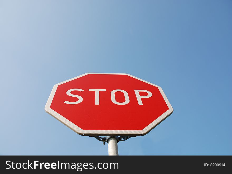 Stop sign on the blue sky