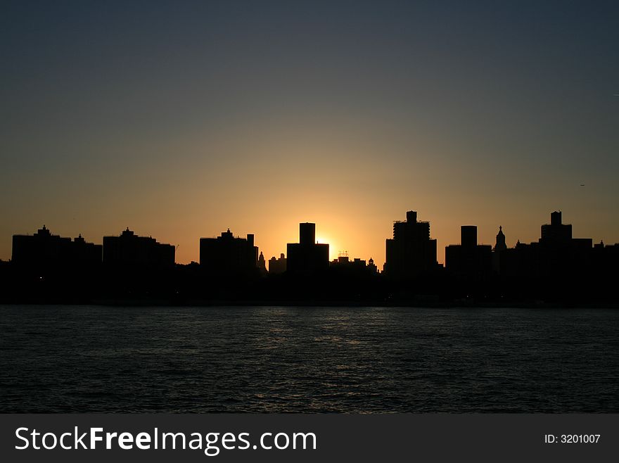 Shot, from a cruise tour, of the East side of Manhattan at sundown in late summer. Shot, from a cruise tour, of the East side of Manhattan at sundown in late summer.