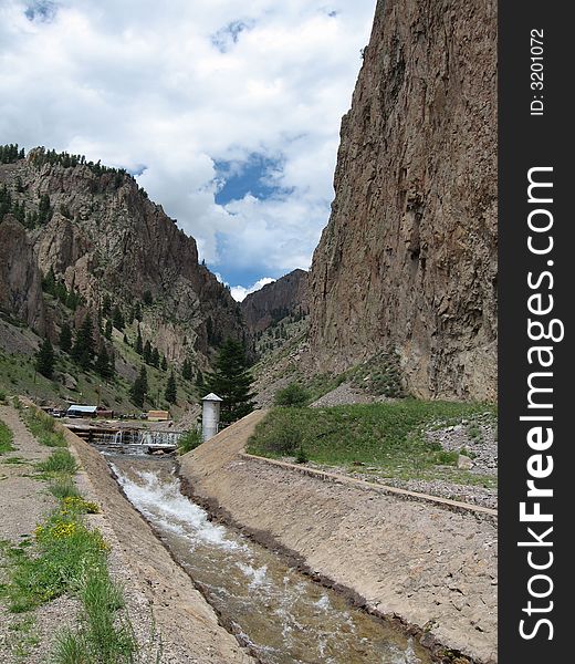 The water flows down a man made chute in the mining town of Creede, Colorado. The water flows down a man made chute in the mining town of Creede, Colorado