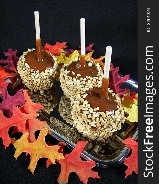 Caramel apples with colorful leaves. Caramel apples with colorful leaves.