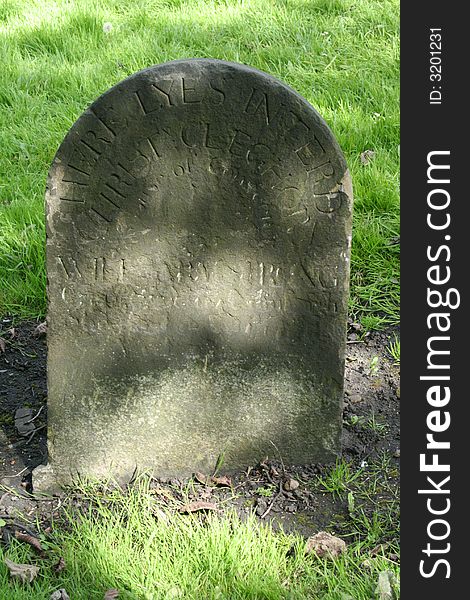 Antique headstone with faded inscription