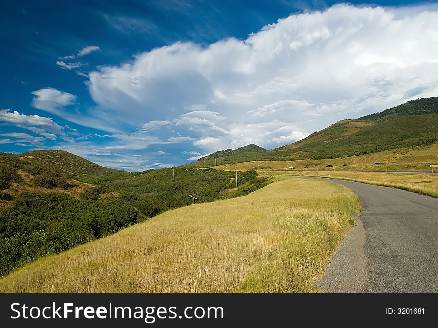 A view of the highway with a dramatic blue sky. A view of the highway with a dramatic blue sky