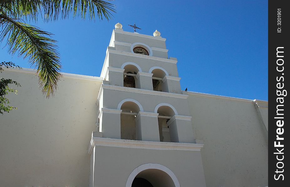 Old mission style church in a mexican village plaza.