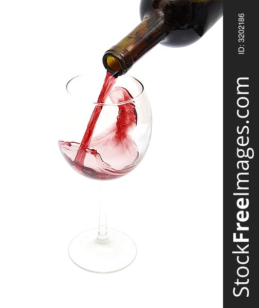 Pouring red wine from a bottle isolated against white background