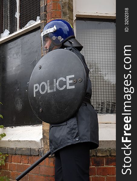 Female British Police Officer in Riot equipment. Female British Police Officer in Riot equipment.