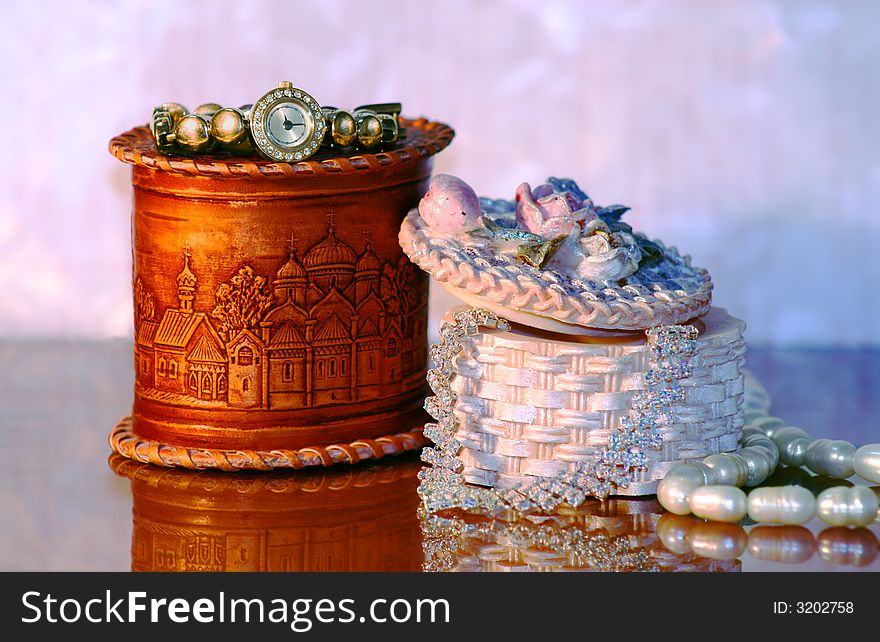 Necklace and gold watch and pearl in small boxs