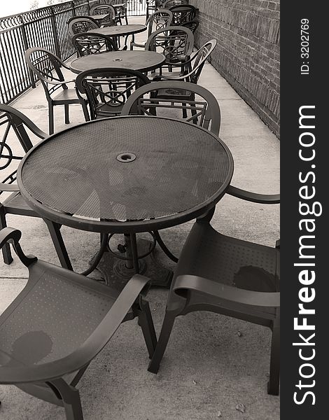 Steel tables in line at an outside resturaunt