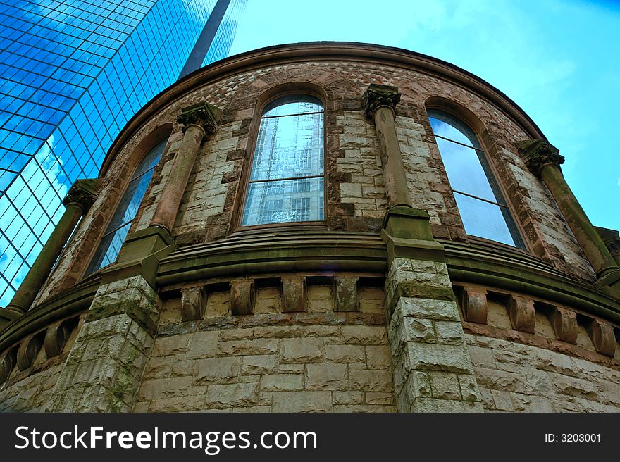 Wide angle view of round room sanctuary at the trinity church in boston, showing stained glass and castle like features