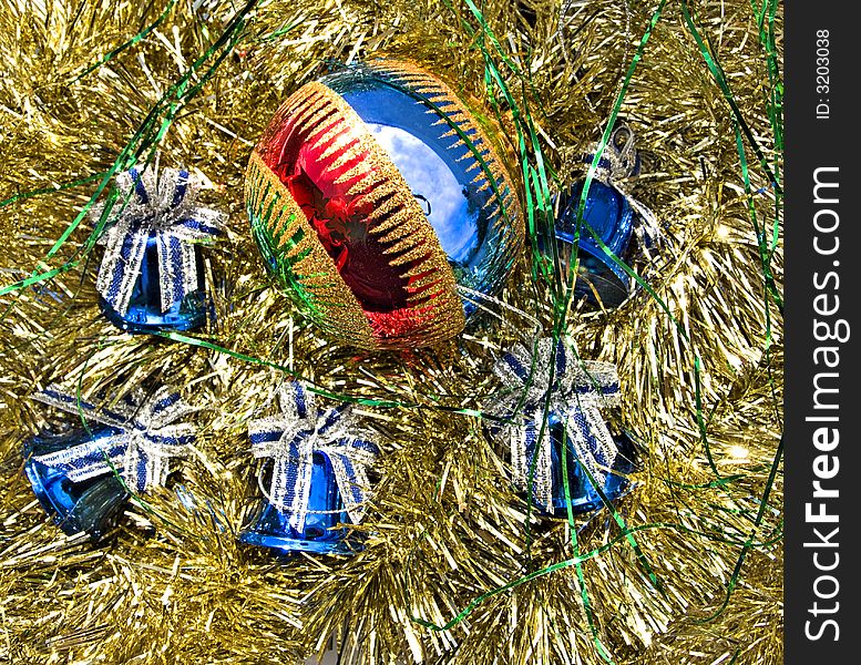 Colorful Christmas ball and five bells on golden decorations. Colorful Christmas ball and five bells on golden decorations