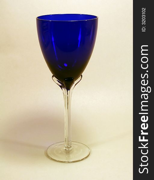 A blue glass chalice isolated on a light background with clipping path. A blue glass chalice isolated on a light background with clipping path.