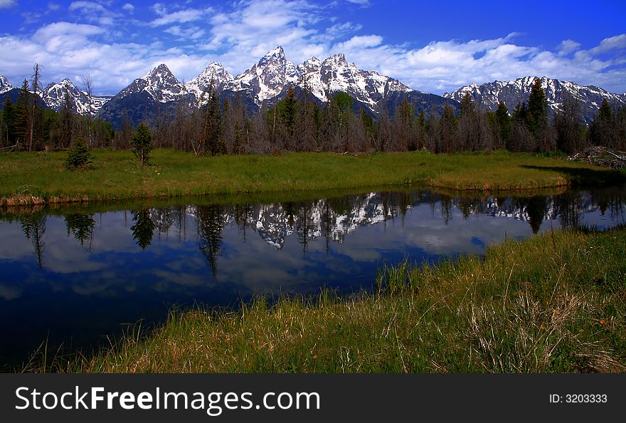 Teton's reflected in side channel of the Snake River, Grand Teton National Park, Wyoming. Teton's reflected in side channel of the Snake River, Grand Teton National Park, Wyoming