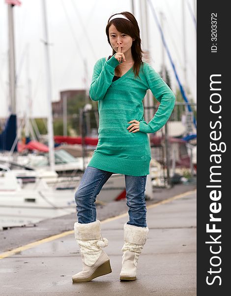 girl in green wearing boots is making face. girl in green wearing boots is making face.
