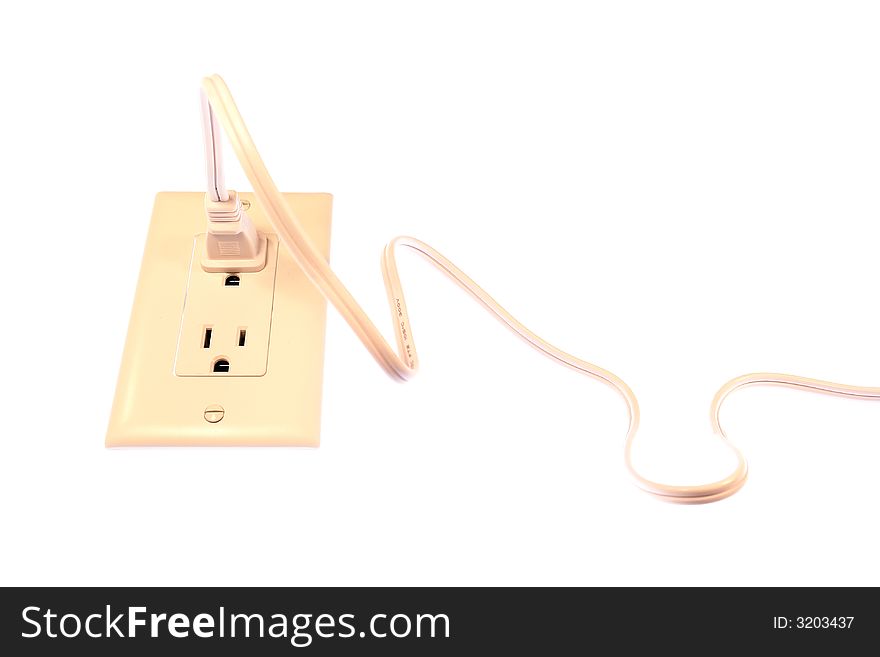 Extension cord plugged into an outlet isolated on a white background