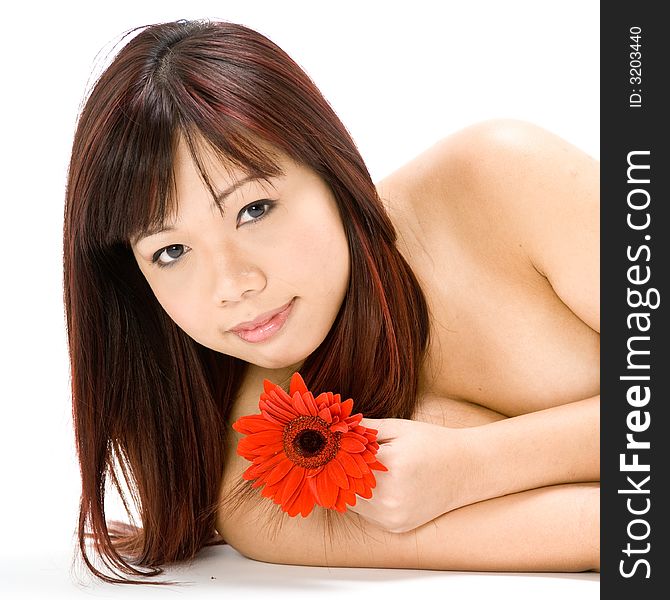 An attractive young Asian woman in white top holding a red flower on white background. An attractive young Asian woman in white top holding a red flower on white background