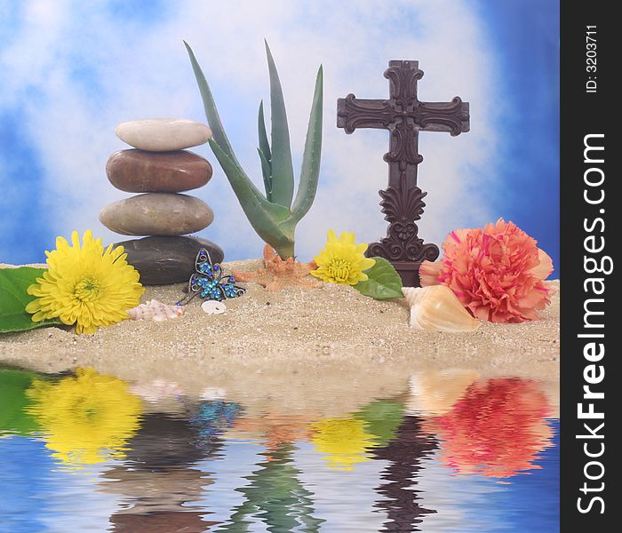 Cross and Flowers on Sand With Aloe Vera Plant