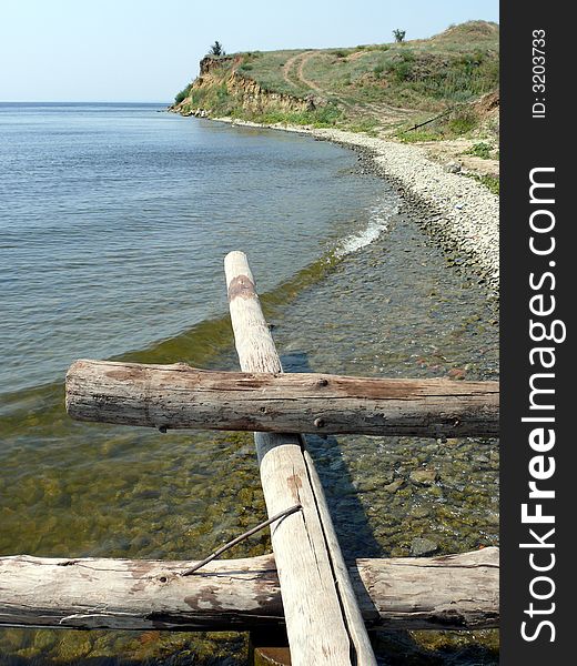 Logs and stones on seacoast