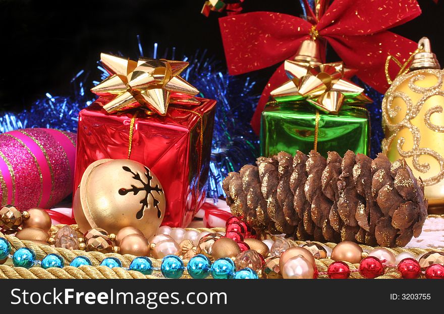 Christmas Gifts With Beads and Pine Cone on Black Background. Christmas Gifts With Beads and Pine Cone on Black Background