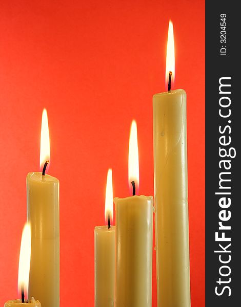 Candles over red background