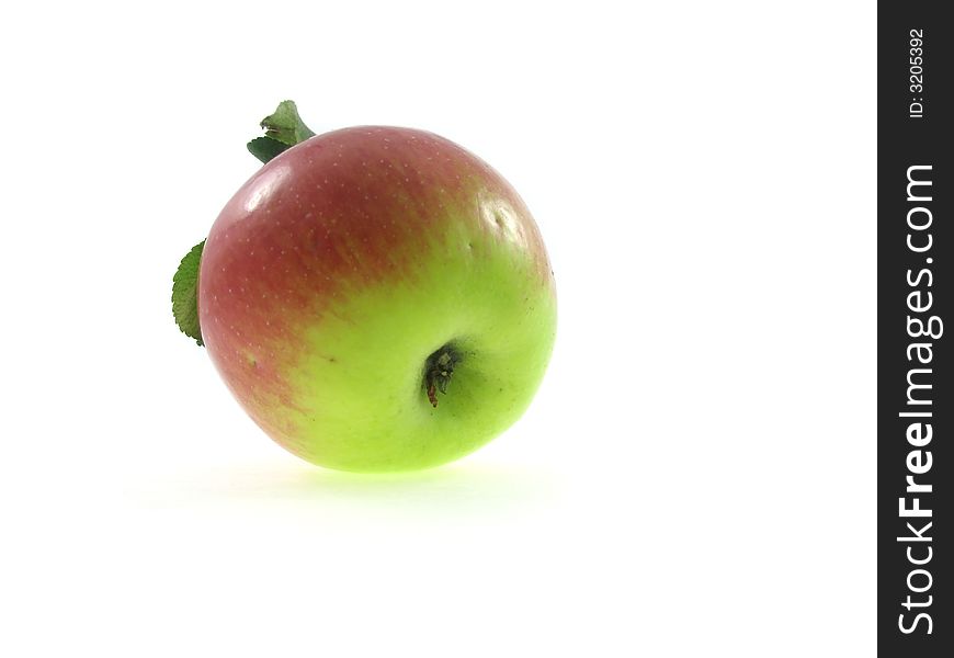 The isolated red apple with green foliage on a white background. The isolated red apple with green foliage on a white background.