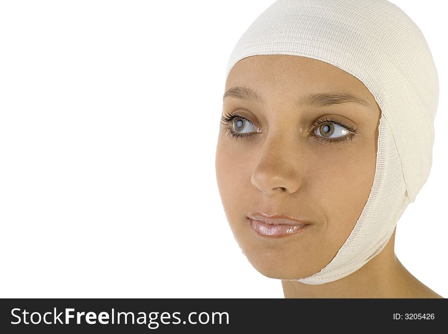 Young, beautiful woman with bandage on head. Smiling and looking at something. Side view, white background