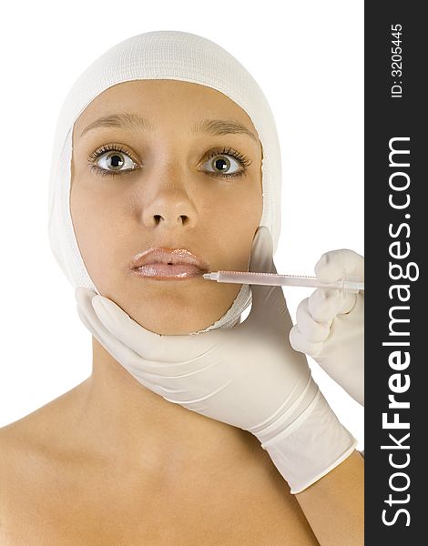 Young, beautiful woman with bandage on head. Somebody is injecting something in her's lips. Front view, white background. Young, beautiful woman with bandage on head. Somebody is injecting something in her's lips. Front view, white background