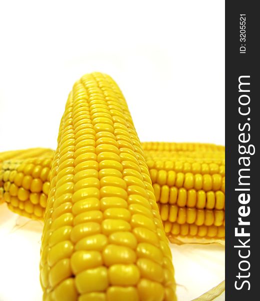 An ear of sweet corn isolated on a white background. An ear of sweet corn isolated on a white background