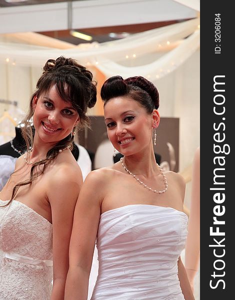 Two young, pretty women in wedding dresses. Two young, pretty women in wedding dresses.