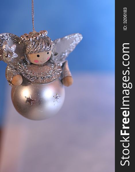 Silver toy angel on blue and white background,christmas decoration