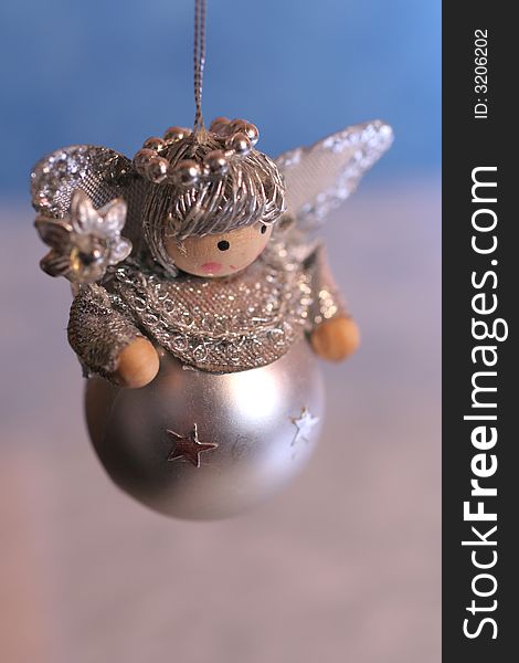 Silver toy angel on blue and white background,christmas decoration