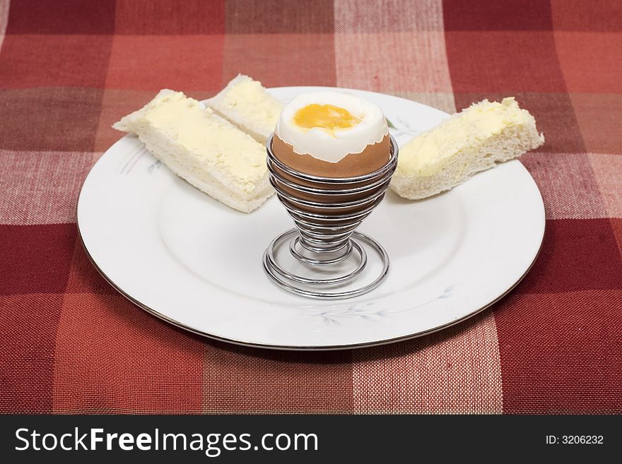 A soft boiled egg with bread soldiers. A soft boiled egg with bread soldiers