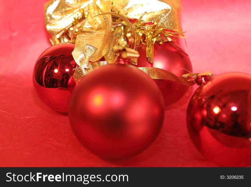 Three red christmas baubles and a golden bow ,christmas decoration. Three red christmas baubles and a golden bow ,christmas decoration