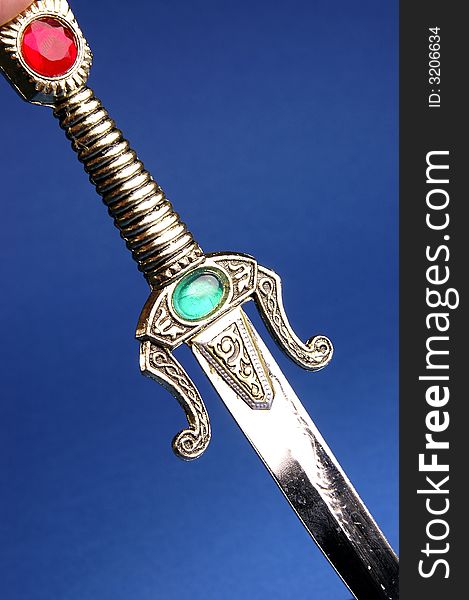 Photo of ornamental knife on the blue background