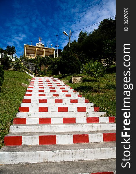 Temple high up a hill with blue sky shot froma low dramatic angle. Temple high up a hill with blue sky shot froma low dramatic angle