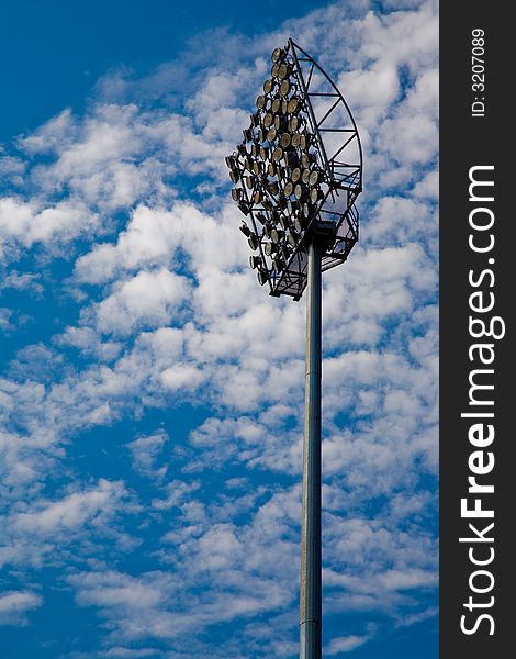 Stadium flood light with blue sky as background. Stadium flood light with blue sky as background