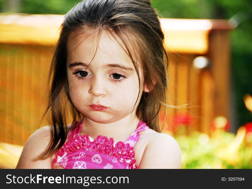 A brunette child looking very serious. A brunette child looking very serious.