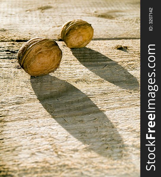 Two hard walnutes on a desk